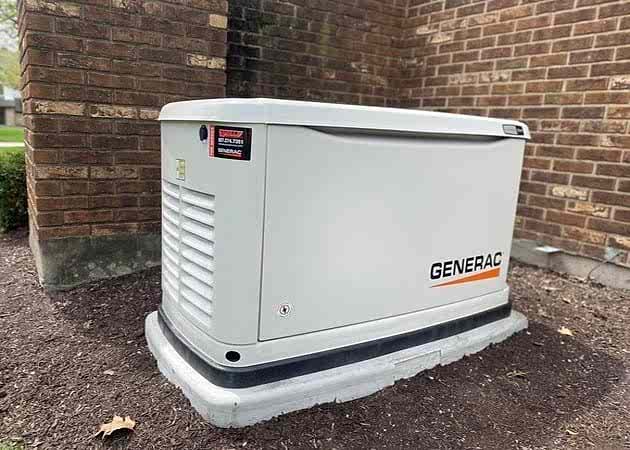 home generators Wells Electric S Generac generator installed on dirt next to brick building