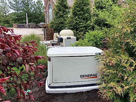 Generac generator installed next to trees